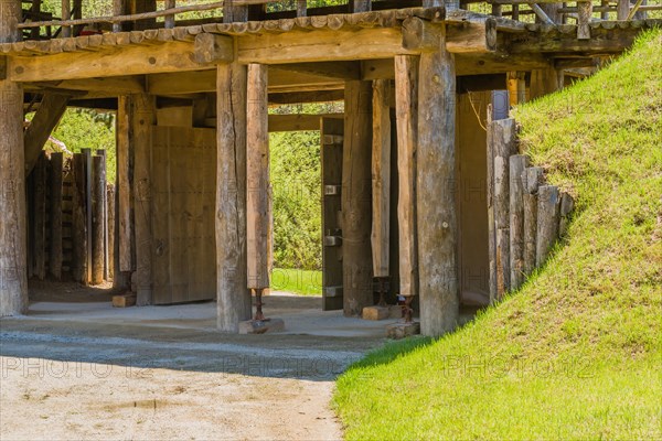 Wooden gate of traditional village made of logs and wooden planks with house jacks holding up