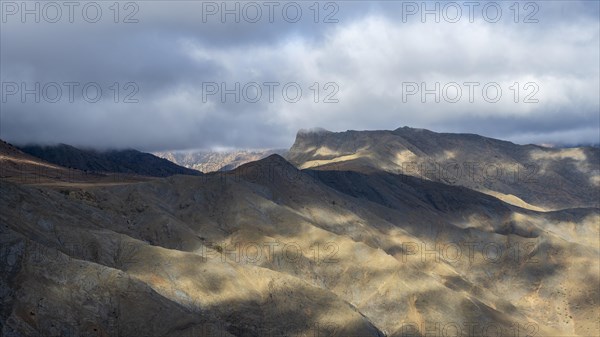 Low hanging clouds in the mountain landscape at the Tizi-n-Tichka pass road, High Atlas, Morocco,