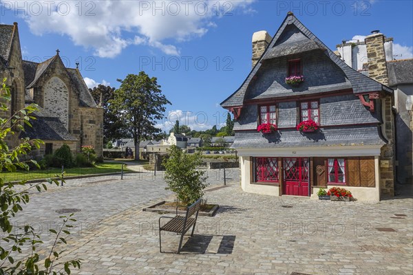 Rue du General de Gaulle in the old town centre of Le Faou with slate-roofed granite houses from