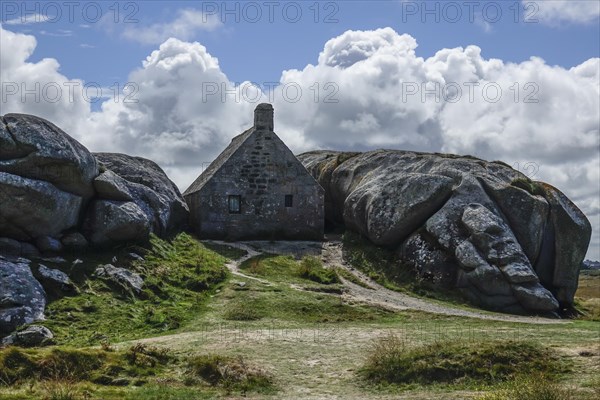 Former village of Meneham on the Atlantic coast with partly thatched houses between granite rocks,