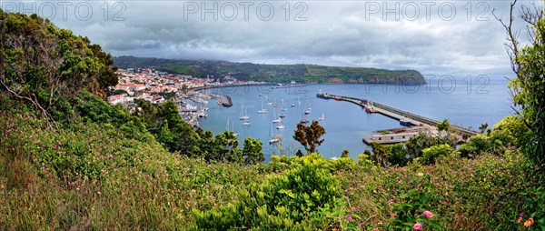 Panoramic view from Monte da Guia to a coastal town Horta with harbour and sailing boats,