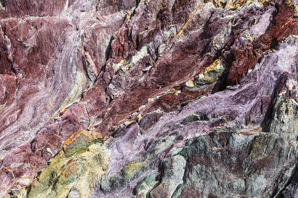 Coloured, ferrous mineral rocks on the beach of Topinetti, near Rio Marina, Elba, Tuscan