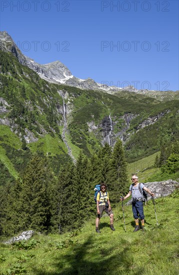 Mountaineer in front of mountain landscape, waterfalls of the Kesselbach, rocky mountain peaks,