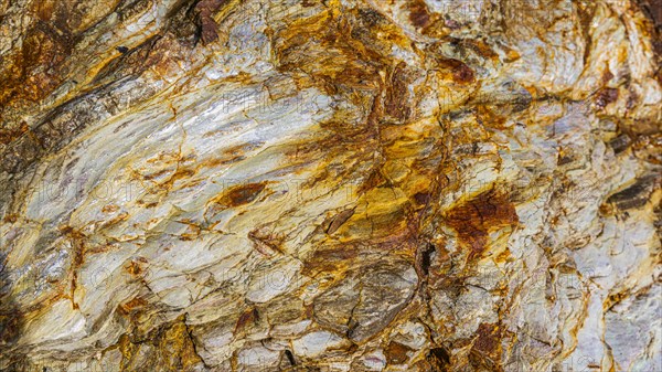 Coloured, ferrous mineral rocks on the beach of Topinetti, near Rio Marina, Elba, Tuscan