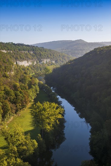 River with gorge and autumnal coloured forest, valley of the Loue, Lizine, near Besancon,
