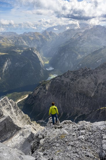 Mountaineer on the rocky summit of the Watzmann Mittelspitze, Watzmann crossing, view of mountain