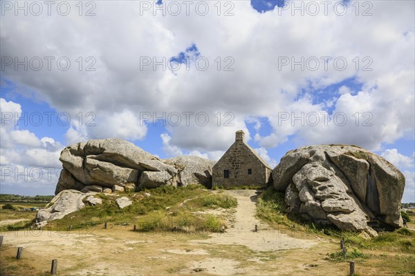 Former village of Meneham on the Atlantic coast with partly thatched houses between granite rocks,