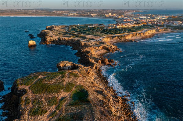 Aerial landscape of Peniche, Portugal, peninsula and town at sunset. Summer sunset haze, little