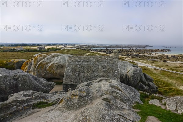 Former village of Meneham on the Atlantic coast with house between granite rocks, coast on the