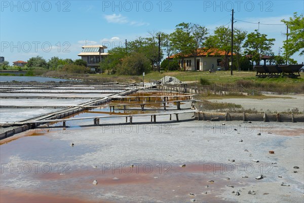 Salt extraction plant with natural landscape in the background and a clear blue sky, therapeutic