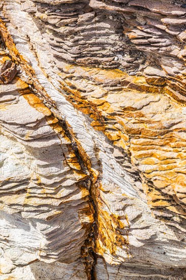 Coloured, ferruginous mineral sandstone on Topinetti beach, near Rio Marina, Elba, Tuscan