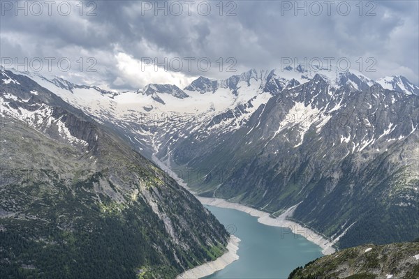 Mountain landscape, view of Schlegeis reservoir with dam wall, glaciated rocky mountain peaks Hoher