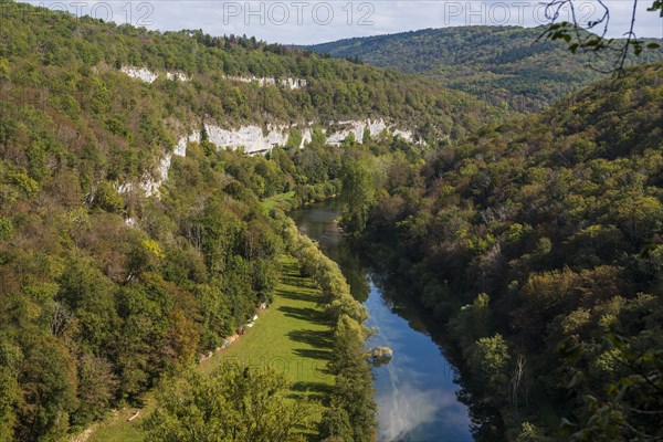 River with gorge and autumnal coloured forest, valley of the Loue, Lizine, near Besancon,