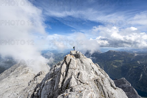 Mountaineer on the rocky summit of the Watzmann Mittelspitze, Watzmann crossing, view of mountain
