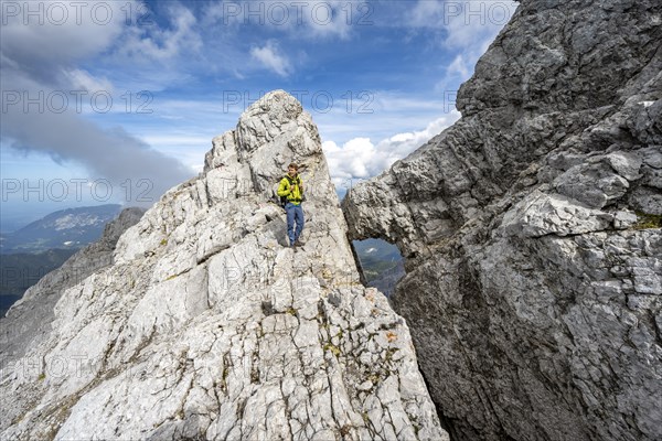 Mountaineer on a narrow rocky ridge, Watzmann crossing to Watzmann Mittelspitze, view of mountain