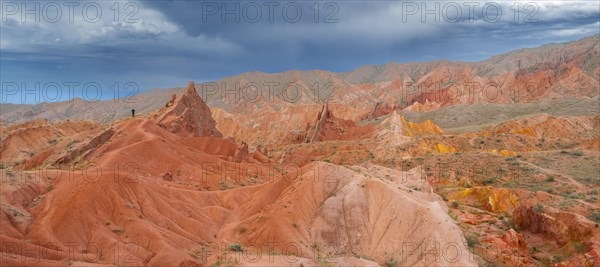 Eroded mountain landscape, sandstone cliffs, canyon with red and orange rock formations, Konorchek