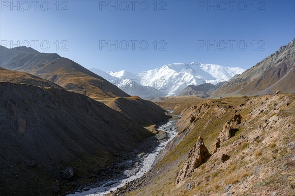 Achik Tash river, Achik Tash valley, behind glaciated and snow-covered mountain peak Pik Lenin,