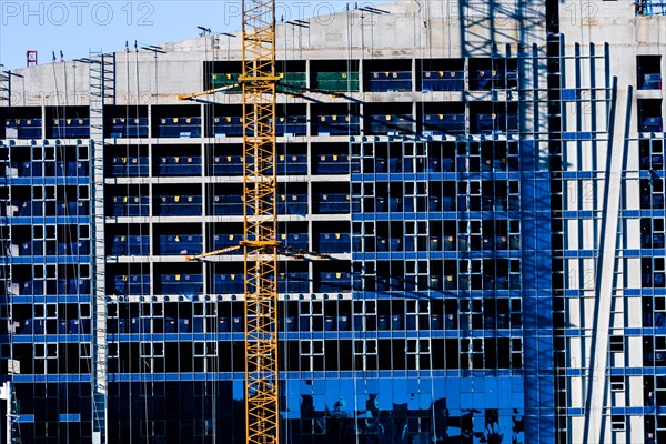 Yeoso, South Korea: December 25, 2017: Yellow crane attached to side of building that is under