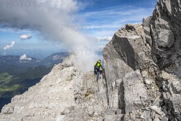 Mountaineer on a narrow rocky ridge, Watzmann crossing to Watzmann Mittelspitze, view of mountain
