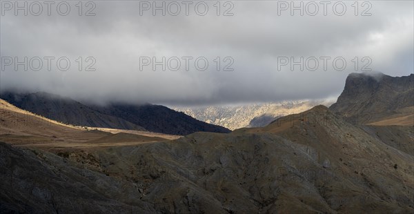 Low hanging clouds in the mountain landscape at the Tizi-n-Tichka pass road, High Atlas, Morocco,