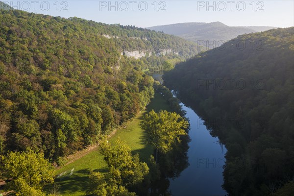 River with gorge and autumnal coloured forest, valley of the Loue, Lizine, near Besancon,