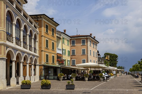 Waterfront promenade with restaurants in Gargnano, Lake Garda, Province of Brescia, Lombardy,