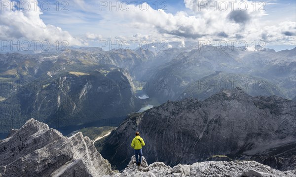 Mountaineer on the rocky summit of the Watzmann Mittelspitze, Watzmann crossing, view of mountain