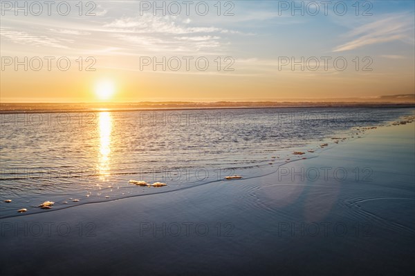 Atlantic ocean sunset with surging waves at Fonte da Telha beach, Costa da Caparica, Portugal,