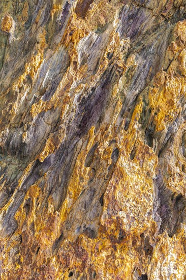 Coloured, ferrous mineral rocks on the beach of Topinetti, near Rio Marina, Elba, Tuscan