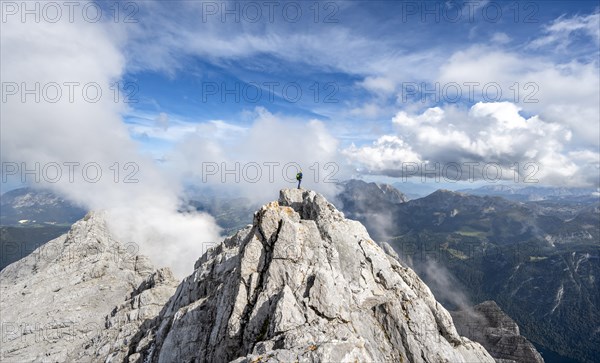 Mountaineer on the rocky summit of the Watzmann Mittelspitze, Watzmann crossing, view of mountain