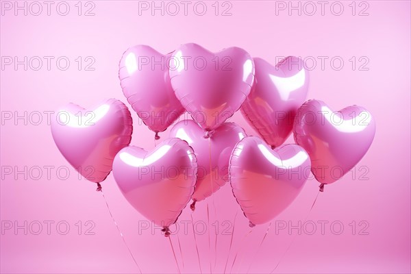 Bunch of glossy pink heart-shaped balloons against a soft pink background, perfect for Valentine's