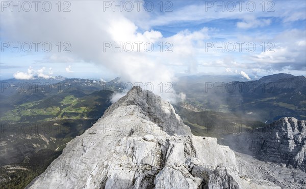 Rocky narrow mountain ridge with summit Watzmann Hocheck, view from Watzmann middle summit to