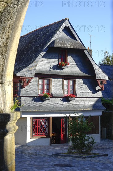 Rue du General de Gaulle in the old town centre of Le Faou with slate-roofed granite houses from