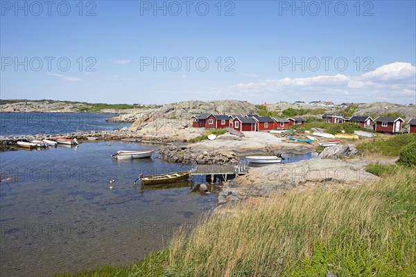 Red wooden houses on the archipelago island of Hoenoe, Oeckeroe municipality, Vaestra Goetalands