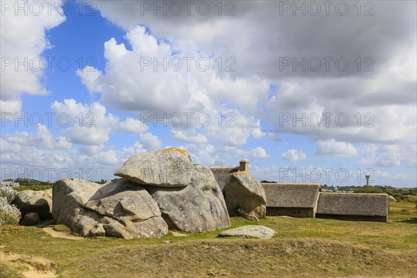 Former village of Meneham on the Atlantic coast with partly thatched houses between granite rocks,