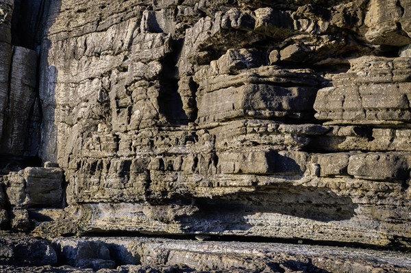 Beautiful texture of cliffs and rock formations in Peniche, Portugal, on sunny day. Weathered rock