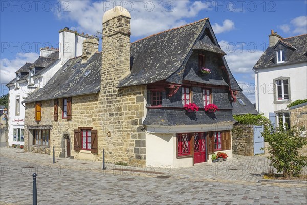Rue du General de Gaulle in the old town centre of Le Faou with slate-roofed granite houses from