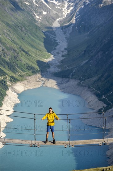Mountaineers on a suspension bridge, picturesque mountain landscape near the Olpererhuette, view of