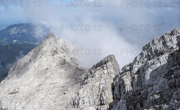 Rocky mountain ridge with clouds, Watzmann crossing, at the summit of the Watzmann Mittelspitze,