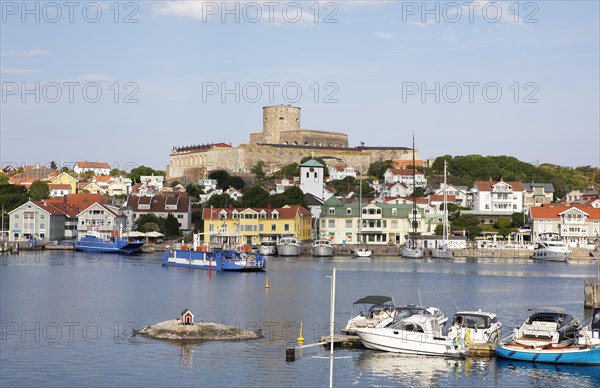 Ferry in the harbour of the archipelago island Marstrandsoe, behind the fortress Carlsten,