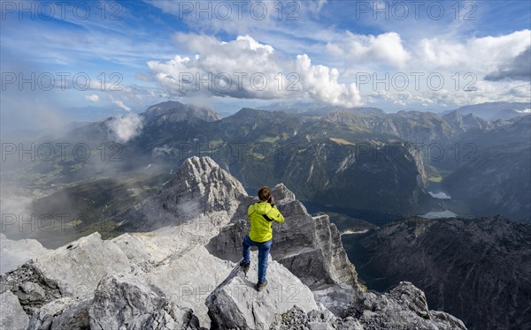 Mountaineer on the rocky summit of the Watzmann Mittelspitze, Watzmann crossing, view of mountain