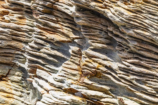 Coloured, ferruginous mineral sandstone on Topinetti beach, near Rio Marina, Elba, Tuscan