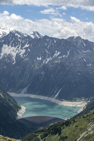 Dam, dam wall of the Schlegeis reservoir in a mountain valley, reservoir lake with turquoise blue