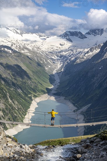 Mountaineers on a suspension bridge over a mountain stream Alelebach, picturesque mountain