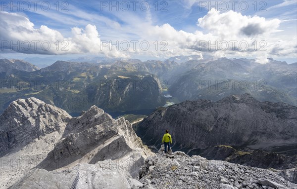 Mountaineer on the rocky summit of the Watzmann Mittelspitze, Watzmann crossing, view of mountain