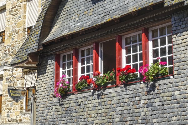 Rue du General de Gaulle in the old town centre of Le Faou with slate-roofed granite houses from