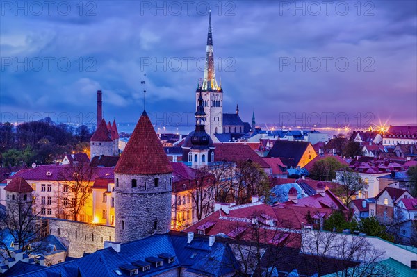 Aerial view of Tallinn Medieval Old Town with St. Olaf's Church and Tallinn City Wall illuminated