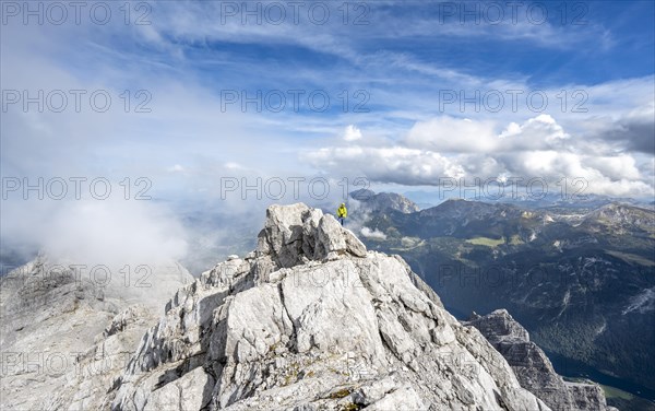 Mountaineer on the rocky summit of the Watzmann Mittelspitze, Watzmann crossing, view of mountain
