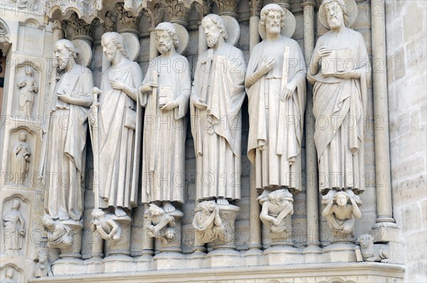 Figures of saints, detail on the Gothic entrance portal of Notre Dame de Paris Cathedral, Paris,