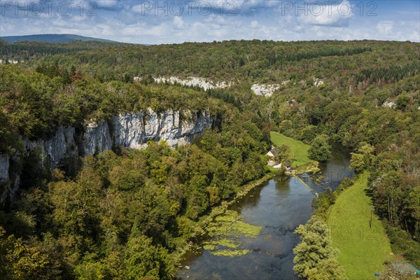 River with gorge and autumnal coloured forest, valley of the Loue, Lizine, near Besancon,